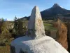 Smoldering stone temple in the foreground with the Châtel