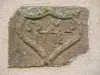 Engraved stone, difficult to read, in a wall (© JE)