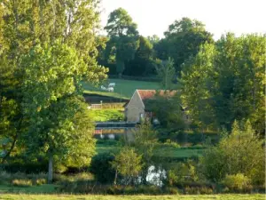Mill Lugny with wheel and picnic area in front of the village