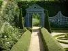 Ainay-le-Vieil castle - Montreuils chartreuses: garden with path, flowerbeds and fences