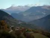 Alps landscapes in the Savoie - Trees with autumn colours, mountain villages and mountains covered with forests