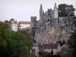 Angles-sur-l'Anglin - Ruins of the fortified castle (medieval fortress) on a rocky mountain spur, houses of the village and trees