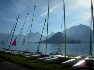 Annecy lake - In Talloires: catamarans lined up on the shore with view of the lake and mountains