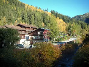 Argentière - River, chalets of the village (ski resort), trees and forest in autumn