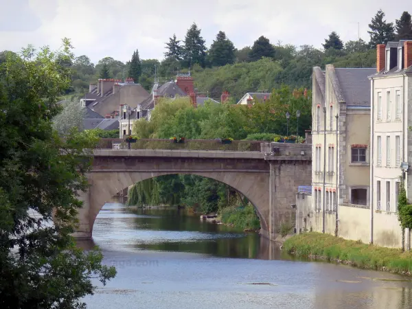 Argenton-sur-Creuse - Bridge spanning River Creuse, trees and houses along the water; in the Creuse valley