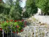 Aulus-les-Bains - Flower-decked bridge spanning the river, trees lining the waterfront and houses of the village (spa town); in the Ariège Pyrenees Regional Nature Park, in the Garbet valley