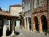 Auvillar - Toscaanse zuilen van de graanschuur en ronde huizen met arcades van de Place de la Halle
