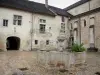 Baume-les-Messieurs - Abbey: fountain of the cloister's yard, abbatial building, arched passage and Saint-Pierre abbey church