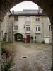 Baume-les-Messieurs - Abadía: el arco en el primer plano, patio, edificios de la abadía y arco