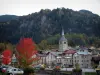 Beaufort - Trees with lively autumn colours, church and houses of the village, forest