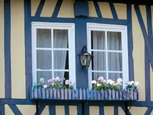 Le Bec-Hellouin - Flower-bedecked window of a blue half-timbered house