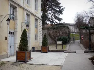 Belley - Facade of the episcopal palace, potted shrubs and alley leading to the park 