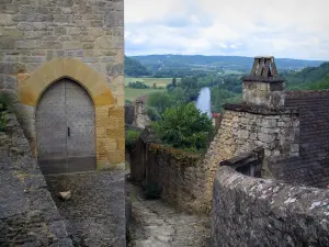 Beynac-et-Cazenac - Narrow paved street in the village with view of the Dordogne valley (river), in Périgord