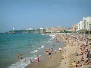 Biarritz - Grande Plage beach and tourists, waterfront of the resort, lighthouse of the Saint-Martin headland and the Atlantic Ocean