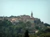 La Cadière-d'Azur - View of trees, houses and church bell tower in the hilltop village