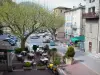 Castellane - Piazza della Chiesa: bar con terrazza, alberi e facciate di case