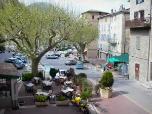 Castellane - Église square: café terrace, trees and facades of houses