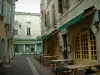 Castres - Narrow street of the old town with restaurant terrace and houses