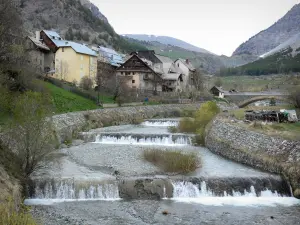 Cervières - Houses of the village on the Cerveyrette torrent and mountains