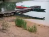 Chalain lake - Sandy beach, reeds, boats moored to a pontoon and a lake