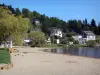 Chambon lake - Beach, lake, houses and trees; in the Auvergne Volcanic Regional Nature Park, in the Monts Dore mountain area 