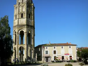 Charroux - Octagonal tower said Charlemagne tower (remains of the Saint-Sauveur abbey), houses of the city, café terrace and lampposts