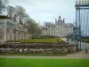 Château de Balleroy - Railing at the entrance, outbuildings, flowerbeds, castle, trees, and cloudy sky