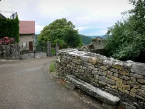 Château-Chalon - Muro di pietra, strada, casa e gli alberi