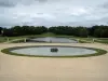 Château de Chantilly - Park: French-style formal garden of Le Nôtre: Gerbe ornamental lake, La Manche, statues, flowerbeds, and trees of the park in background