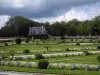 Château de Chenonceau - Formal flowerbeds and shrubs of the Diane de Poitiers garden, Chancellery, trees and clouds in the sky