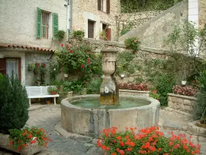 Châteaudouble - Small square decorated with flowers, a fountain, geranium flowers (geraniums), and houses of the village