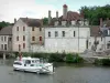 Clamecy - Leisure boat sailing on River Yonne and facades of houses along the Bethléem quay