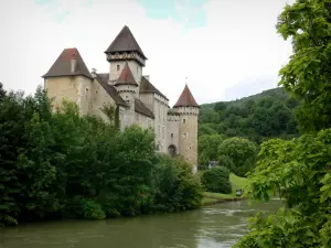 Cléron castle - Fortified castle, Loue river and trees along the water