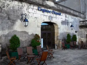 Cognac - Château of Cognac (Valois castle, François I castle) home to the company Otard Cognacs: entrance courtyard decorated with chairs and small tables