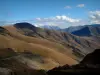 Col de la Croix-de-Fer pass - From the alpine pass, view of alpine pastures ( high meadows) and surrounding mountains, clouds in the sky (Grande Alpes (Alps) road)