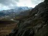 Col de la Croix-de-Fer pass - Cliffs, footpath and mountain with snowy summit (Grande Alpes (Alps) road)