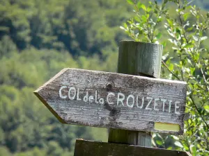 Col de la Crouzette pass - Wooden sign showing the direction to the Col de la Crouzette pass; in the Ariège Pyrenees Regional Nature Park