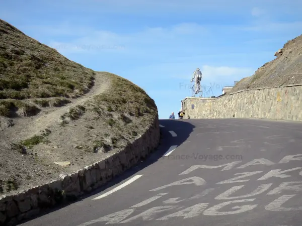 Col du Tourmalet pass - Road to the Col du Tourmalet mountain pass (in the Pyrenees), statue of a cyclist in the background