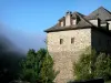 Conques - Stone house surrounded by greenery