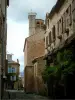 Cordes-sur-Ciel - Narrow street in the medieval town, stone houses and the Saint-Michel church