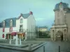 Le Croisic - Aiguillon mansion home to the town hall, square decorated with fountains, houses and turbulent sky