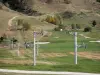 Les Deux Alpes - Grassland and chair lift of the ski resort of Les 2 Alpes in autumn