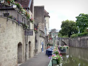 Dole - Houses of the old town and café terrace on the edge of the Tanneurs canal, flowers and trees