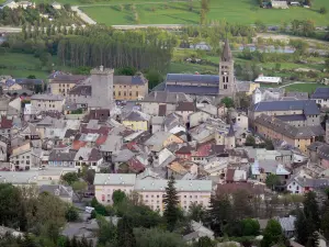 Embrun - Bell tower of the Notre-Dame-du-Réal cathedral, Brune tower (former keep of the archbishops) and houses of the old town, Durance river lined with trees (Durance valley)