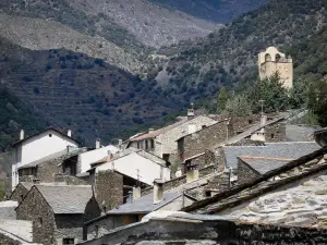 Évol - View of the bell tower of the Saint-André church and the houses with tiled roofs of the village of Évol; in the Regional Natural Park of the Catalan Pyrenees
