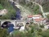 Eyrieux valley - Chervil bridge spanning River Eyrieux, houses and gardens along the water; in the town of Chalencon, in the Regional Natural Park of the Ardèche Mountains