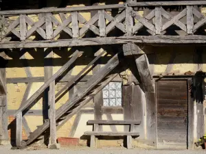 Forest farm-museum - Facade and balcony with wooden braces of the Bressan farmhouse; in Courtes, in Savoyard Bresse 