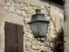 Fourcès - Wall lantern and stone facade of a house in the fortified village