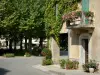 Fourcès - Flower-bedecked house and round square shaded by plane trees