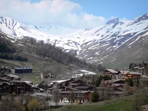 La Foux d'Allos - Chalets and buildings of the ski resort of Val d'Allos 1800, ski lifts and mountains with snowy tops